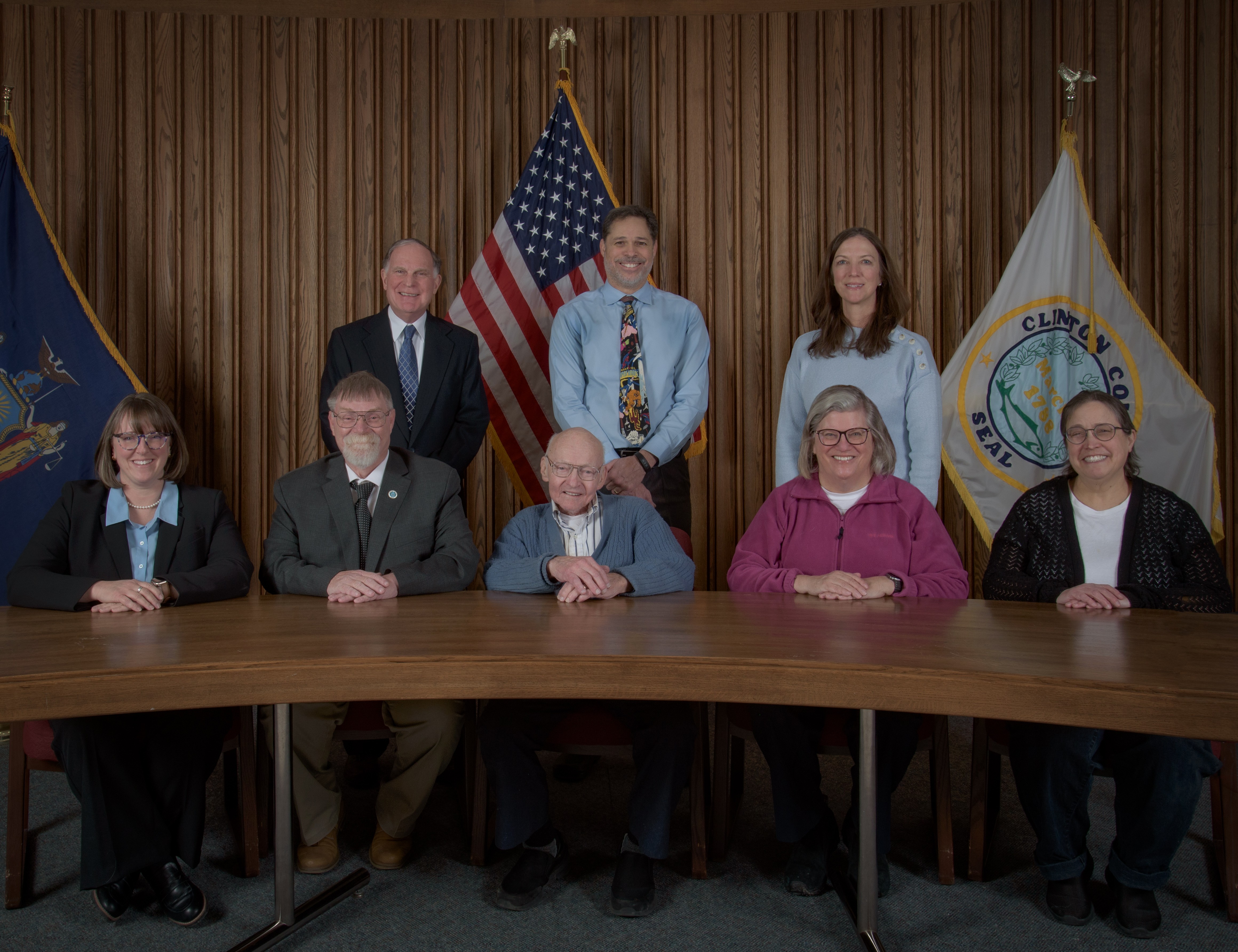 A picture of the board of health members 5 sitting at a table and 3 standing behind them