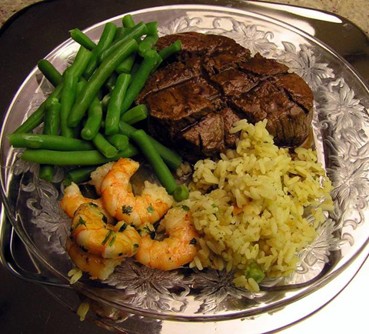 Picture of a meal with Steak, shrimp, green beans and rice